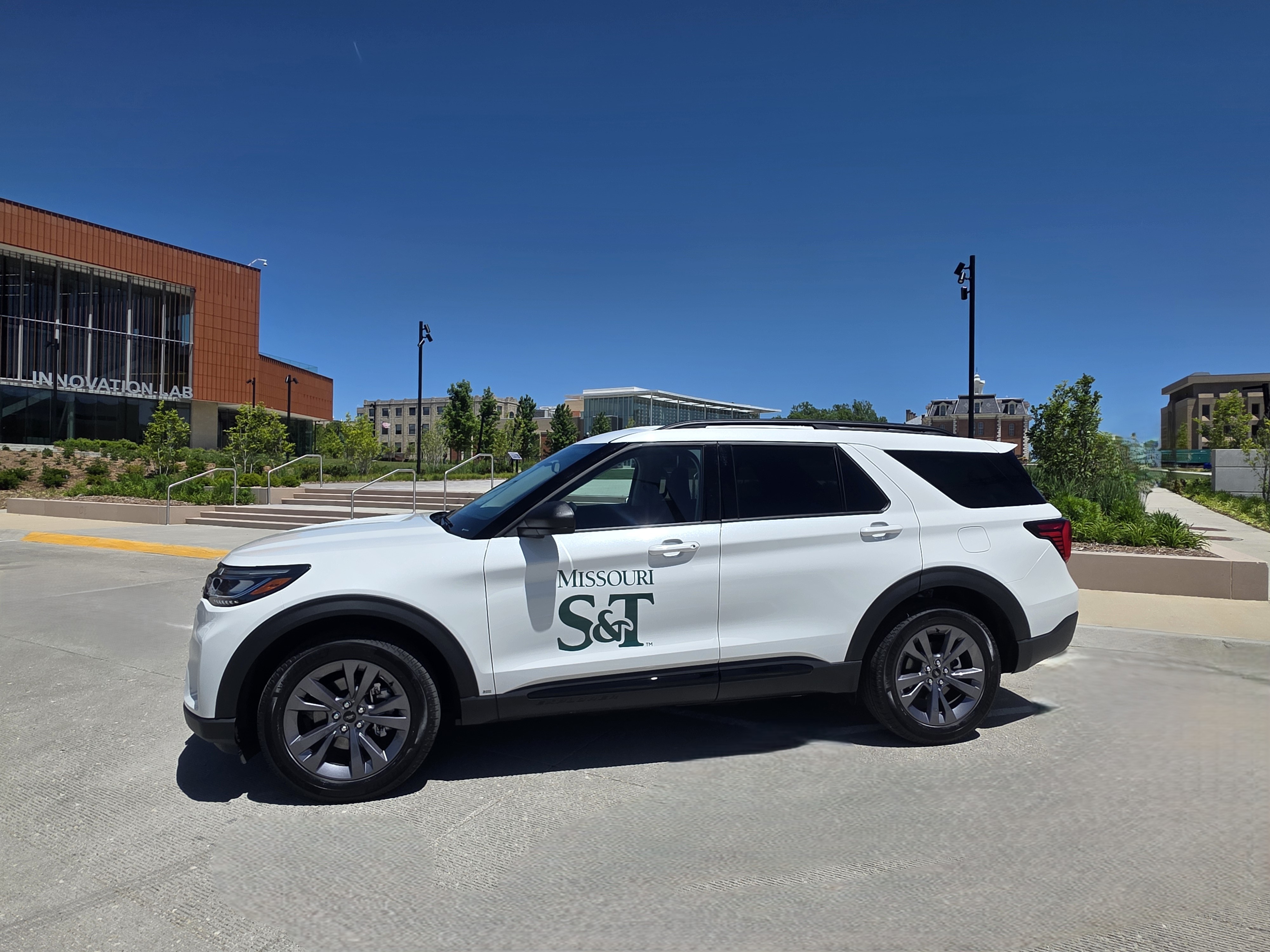 A white Ford Explorer with the Missouri S&T logo on the door.